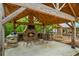 Covered patio with a stone fireplace and built-in grilling station at 915 Rocky Creek Rd, Hampton, GA 30228
