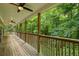 Spacious wooden porch overlooking a wooded landscape at 915 Rocky Creek Rd, Hampton, GA 30228