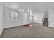 Inviting living room featuring a modern light fixture, staircase, and a front door at 1260 Sailwind Ct, Buford, GA 30518