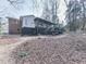 Spacious backyard featuring a deck, wooden staircase, and a mix of brick and siding at 301 Jeanette St, Canton, GA 30114