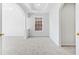 Spacious bonus room featuring neutral carpet, tray ceiling, and natural light at 5819 Rue Chase Way, Tucker, GA 30084