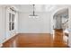 Formal dining room featuring hardwood floors, wainscoting, a tray ceiling, and an elegant chandelier at 5819 Rue Chase Way, Tucker, GA 30084