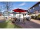 Inviting backyard with a wooden patio featuring an outdoor dining set and a red umbrella at 1470 S Gordon Sw St, Atlanta, GA 30310