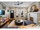 Inviting living area with a fireplace, hardwood floors, and a modern ceiling fan at 1470 S Gordon Sw St, Atlanta, GA 30310