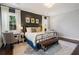 Bright main bedroom with a large bed, white and black wall, white rug, and natural light from windows at 1470 S Gordon Sw St, Atlanta, GA 30310