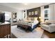 Main bedroom with a metal frame bed, white rug, and an adjacent seating area near bright windows at 1470 S Gordon Sw St, Atlanta, GA 30310