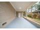 Back porch with brick wall and concrete flooring at 2104 Barbara Ln, Decatur, GA 30032