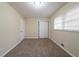 Bedroom with neutral walls, carpet flooring, double door closet, and window providing natural light at 2104 Barbara Ln, Decatur, GA 30032