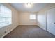 Bedroom featuring neutral walls, carpet flooring, a window providing natural light and closet at 2104 Barbara Ln, Decatur, GA 30032