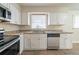 Modern kitchen with stainless steel appliances, granite countertops, and white cabinets at 2104 Barbara Ln, Decatur, GA 30032