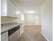 Kitchen with stainless steel dishwasher, granite countertops, and dark wood floor at 2104 Barbara Ln, Decatur, GA 30032