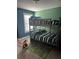 This room features a bunk bed, a window and a colorful rug at 2208 Ginger Lake Ne Dr, Conyers, GA 30013