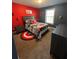 A nicely decorated bedroom with superhero themed decor and red accent wall at 2208 Ginger Lake Ne Dr, Conyers, GA 30013