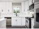 Updated kitchen boasts white cabinets, stainless steel appliances, and stylish backsplash at 1381 Flat Rock Rd, Stockbridge, GA 30281
