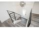 Modern staircase with metal railing leading to the upper level at 1381 Flat Rock Rd, Stockbridge, GA 30281