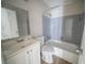 Clean bathroom featuring a white vanity, toilet, and a shower-tub combo at 270 Merrydale Dr, Fayetteville, GA 30215