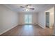 This bedroom features wood floors, ceiling fan, and access to a bathroom and outdoor deck at 270 Merrydale Dr, Fayetteville, GA 30215