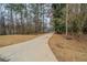 View of the home and front lawn with an extra long driveway at 270 Merrydale Dr, Fayetteville, GA 30215