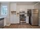 Kitchen featuring stainless appliances, white cabinets, and hardwood floors at 270 Merrydale Dr, Fayetteville, GA 30215