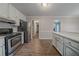 Well-lit kitchen with stainless steel appliances, lots of cabinets, and hardwood floors at 270 Merrydale Dr, Fayetteville, GA 30215