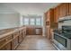 Galley style kitchen with wood cabinets, stainless steel appliances, and wood-look laminate floors at 270 Merrydale Dr, Fayetteville, GA 30215