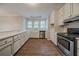Bright kitchen with stainless steel appliances, white cabinets, and hardwood floors at 270 Merrydale Dr, Fayetteville, GA 30215