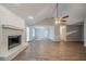 Bright living room with a painted brick fireplace, ceiling fan, and hardwood floors at 270 Merrydale Dr, Fayetteville, GA 30215