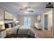 This main bedroom features wood floors, ceiling fan, and access to a bathroom and outdoor deck at 270 Merrydale Dr, Fayetteville, GA 30215
