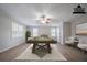 This recreation room features a pool table, wood floors, ceiling fan, and large windows at 270 Merrydale Dr, Fayetteville, GA 30215