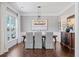 Elegant dining room with hardwood floors, modern chandelier, and ample natural light at 489 Spring View Dr, Woodstock, GA 30188