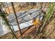 Aerial view of the home's rear exterior featuring a new deck and concrete patio at 1271 Marcelle Heights Pl, Norcross, GA 30093