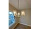 Dining room chandelier with lots of natural light from the large window at 3740 Cobblestone Dr, Loganville, GA 30052