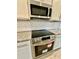 Stainless steel microwave and oven with decorative backsplash in modern kitchen at 3740 Cobblestone Dr, Loganville, GA 30052