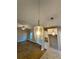 Open concept living room with eat-in kitchen and modern lighting at 3740 Cobblestone Dr, Loganville, GA 30052