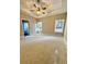 Spacious main bedroom with tray ceiling, fan, and natural light at 3740 Cobblestone Dr, Loganville, GA 30052