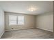 This carpeted bedroom has neutral colored walls and window with blinds at 265 N Fayette Ct, Fayetteville, GA 30214