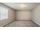 A bedroom with a window, neutral walls, and carpet at 265 N Fayette Ct, Fayetteville, GA 30214