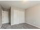 This carpeted bedroom has neutral colored walls and a closet with bi-fold doors at 265 N Fayette Ct, Fayetteville, GA 30214