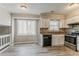 Bright kitchen featuring white cabinets, stainless appliances, and a breakfast nook area with lots of light at 265 N Fayette Ct, Fayetteville, GA 30214