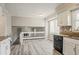 Open kitchen design with bright white cabinets, breakfast bar, view to an adjacent living space at 265 N Fayette Ct, Fayetteville, GA 30214