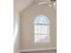 Bright bedroom with arched window and ceiling fan at 521 James Ridge Ln, Stockbridge, GA 30281