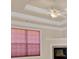 Tray ceiling with crown molding and a ceiling fan at 521 James Ridge Ln, Stockbridge, GA 30281