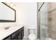 Bathroom with a framed mirror, granite countertop, and tiled glass enclosed shower at 5672 Kingsport Dr # 4, Atlanta, GA 30342