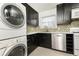 Updated kitchen with stainless steel appliances, dark cabinetry, and a convenient in-unit washer/dryer setup at 5672 Kingsport Dr # 4, Atlanta, GA 30342