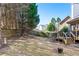 Expansive backyard with mature trees, a wooden fence, and a spacious deck, offering privacy and natural beauty at 1302 Turtlebrook Ln, Lawrenceville, GA 30043