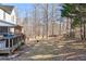 Spacious backyard with a wooden deck, mature trees, and a wooden fence, offering privacy and space at 1302 Turtlebrook Ln, Lawrenceville, GA 30043