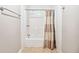 Clean bathroom featuring a shower-tub combination with white tile and neutral shower curtain at 1302 Turtlebrook Ln, Lawrenceville, GA 30043