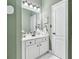 Bathroom vanity area with white cabinetry, granite countertops, and a large mirror at 1302 Turtlebrook Ln, Lawrenceville, GA 30043