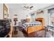 Cozy bedroom featuring a wooden bed frame and dark wood floors with a ceiling fan at 1302 Turtlebrook Ln, Lawrenceville, GA 30043