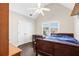 Cozy bedroom features hardwood floors, desk, and double door closet at 1302 Turtlebrook Ln, Lawrenceville, GA 30043
